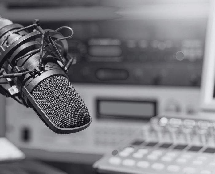 A black and white photo of a podcast production